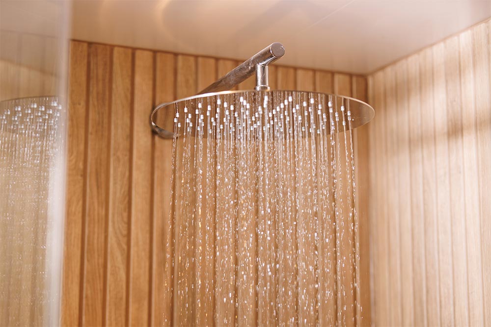 A drench shower head running water