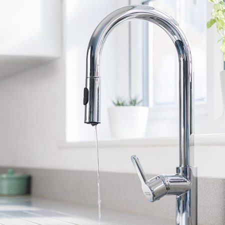 A kitchen tap running water