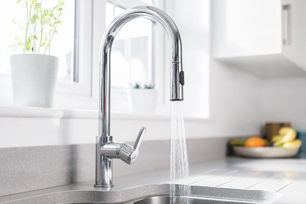 Kitchen tap running a powerful water stream