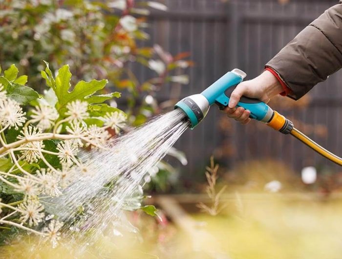 Someone using a powerful outdoor hose