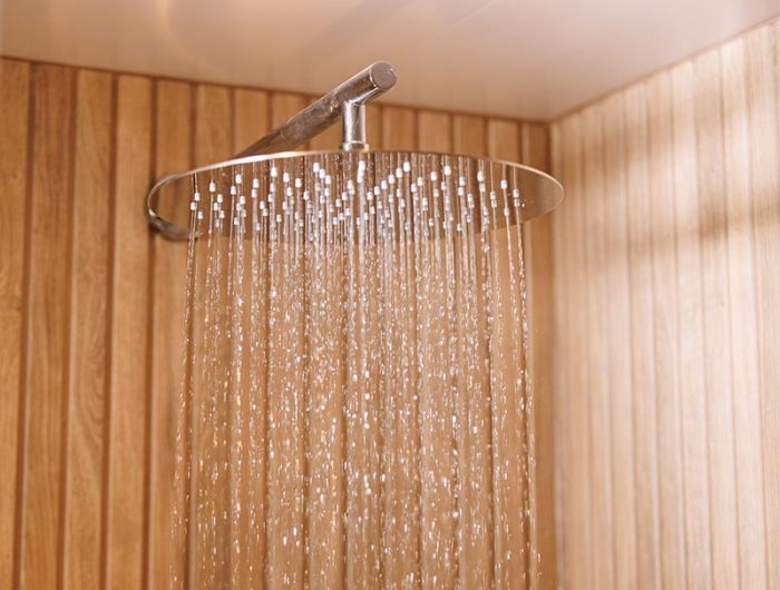 A drench shower head running water