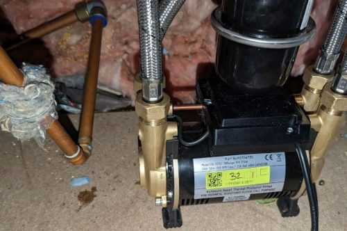 A shower pump set up in a loft